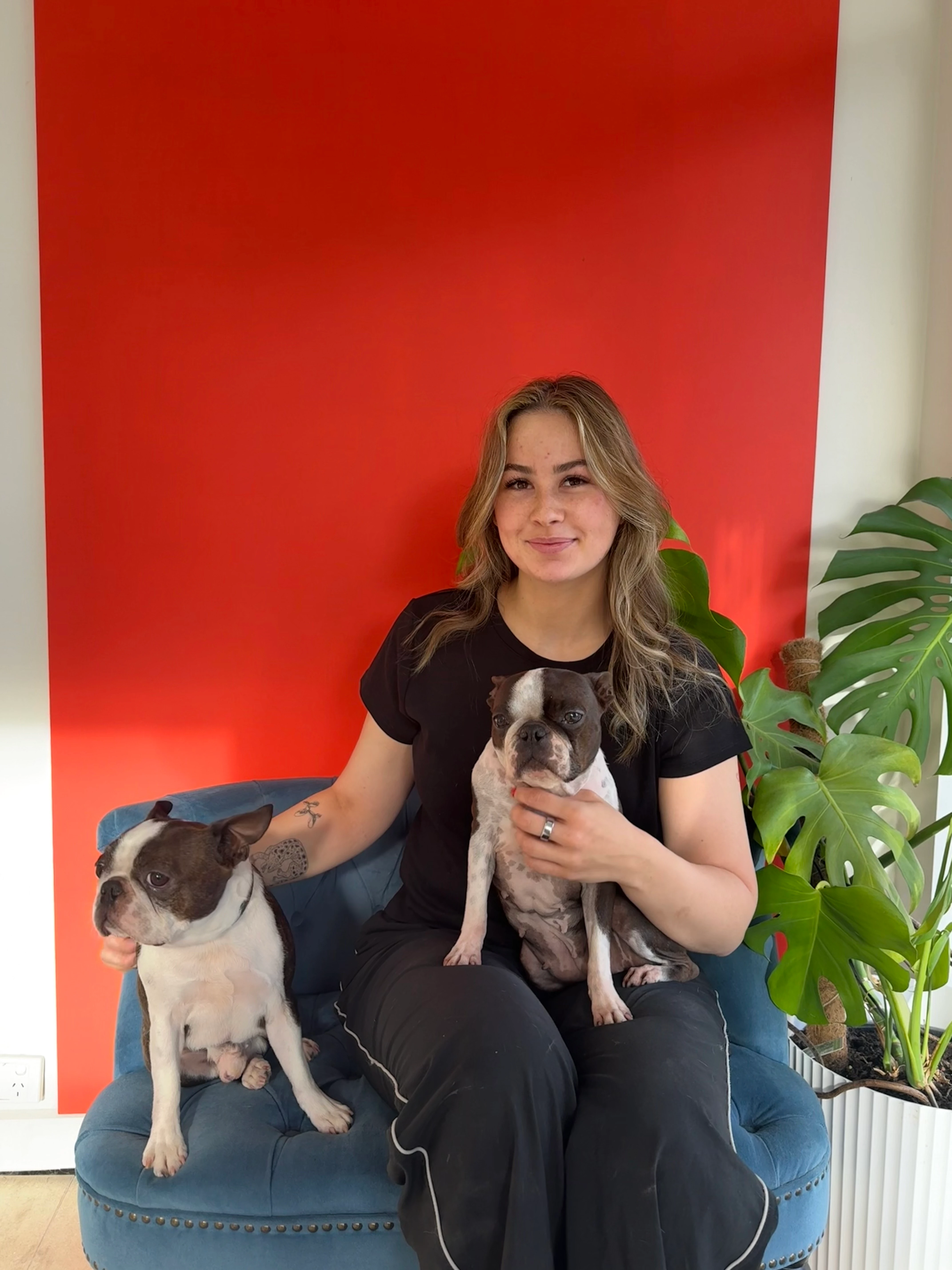 Anna Clarke, owner of The Hair of the Dog, sitting in a blue chair